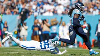 Derrick Henry #22 of the Tennessee Titans runs with the ball for a first down as Rodney Thomas II #25 of the Indianapolis Colts misses a tackle during the first half at Nissan Stadium on October 23, 2022 in Nashville, Tennessee.