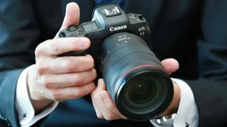 Closeup of person holding Canon EOS R5