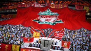Fans holding up a large Liverpool FC flag on the stands in FIFA 22