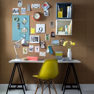 desk with chair and pictures and pegboard