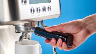 the casabrews ultra espresso machine with 20 bar pressure, a steam wand, LED screen, timer, and tamper accessories, photographed against a blue background