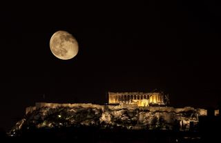 Parthenon on Acropolis Hill of Athens by night with almost full moon