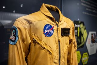 closeup of a yellow nasa flight suit on display at a museum
