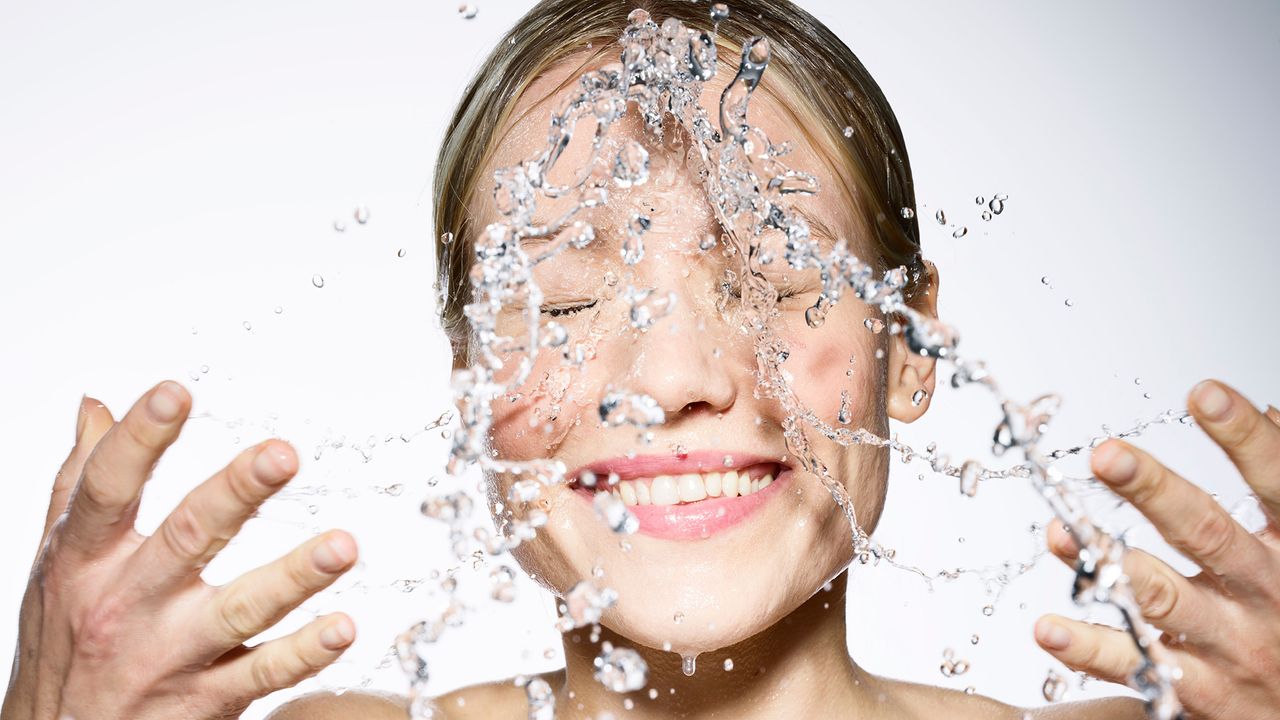 Woman washing her face