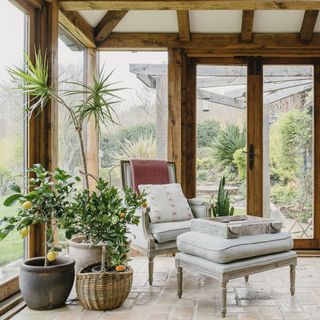 garden room with potted plants and armchair