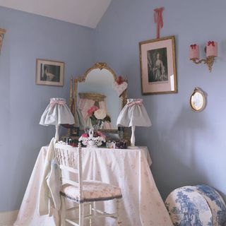 dressing room with blue wall dressing table chair and frame on wall