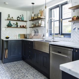 White tiled kitchen with navy cabinets