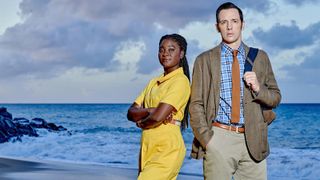 Death in Paradise season 13 stars Neville and Naomi by the sea in Death in Paradise