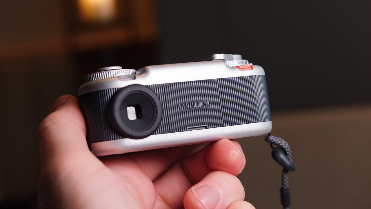 Fujifilm Instax Pal 2 digital camera in user's hand, rear of the camera