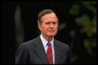 Pres. Bush poised outside (prob. on WH grounds, no caps).