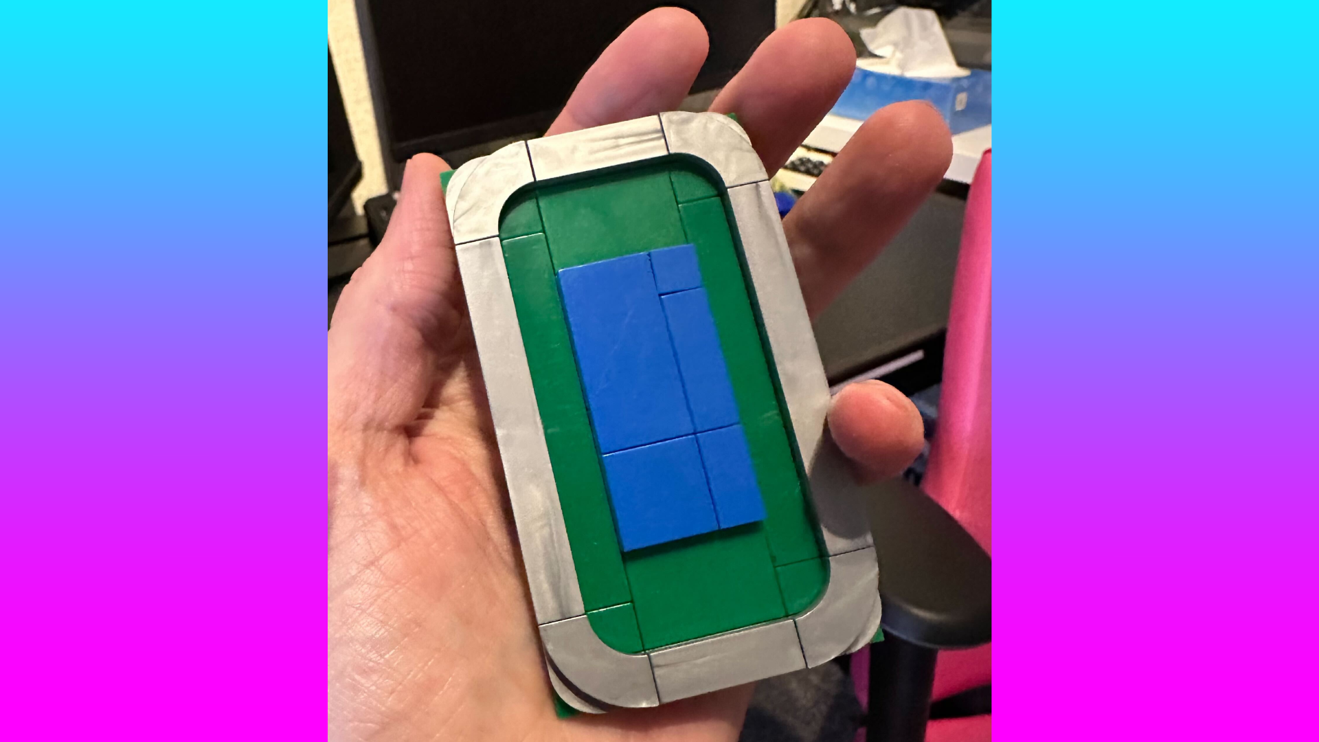 A hand holds a simplified, 3D printer representation of Intel&#039;s Panther Lake chip.