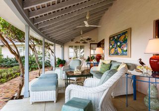 veranda with sofa set and wall painting