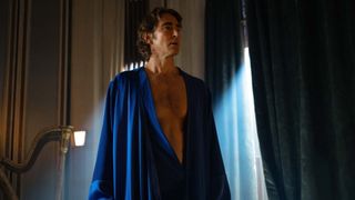 Brother Day stands in a room with a silk blue robe on in Foundation season 2