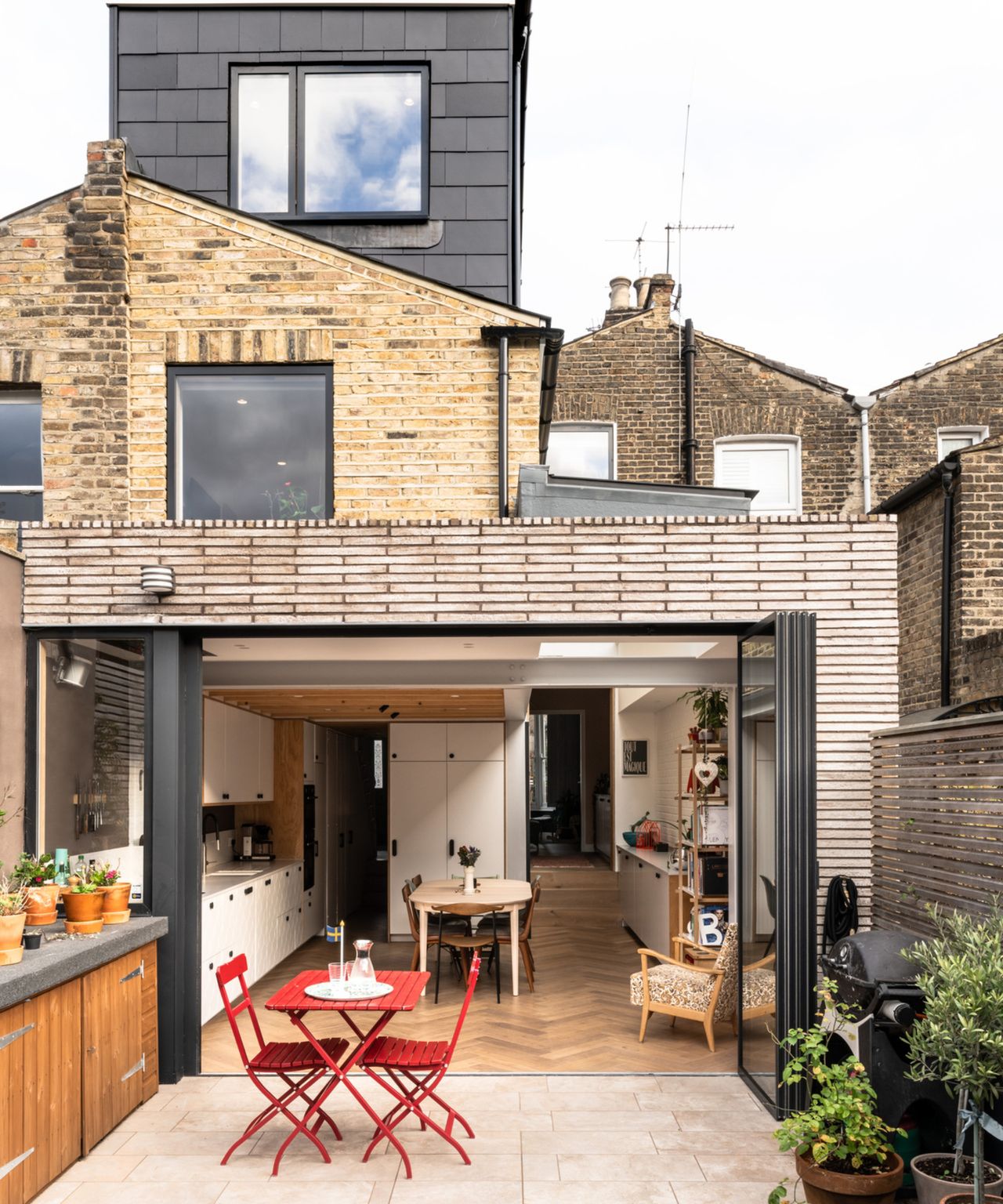 brick extension to rear of property with bi fold windows leading to patio, loft conversion on top of home