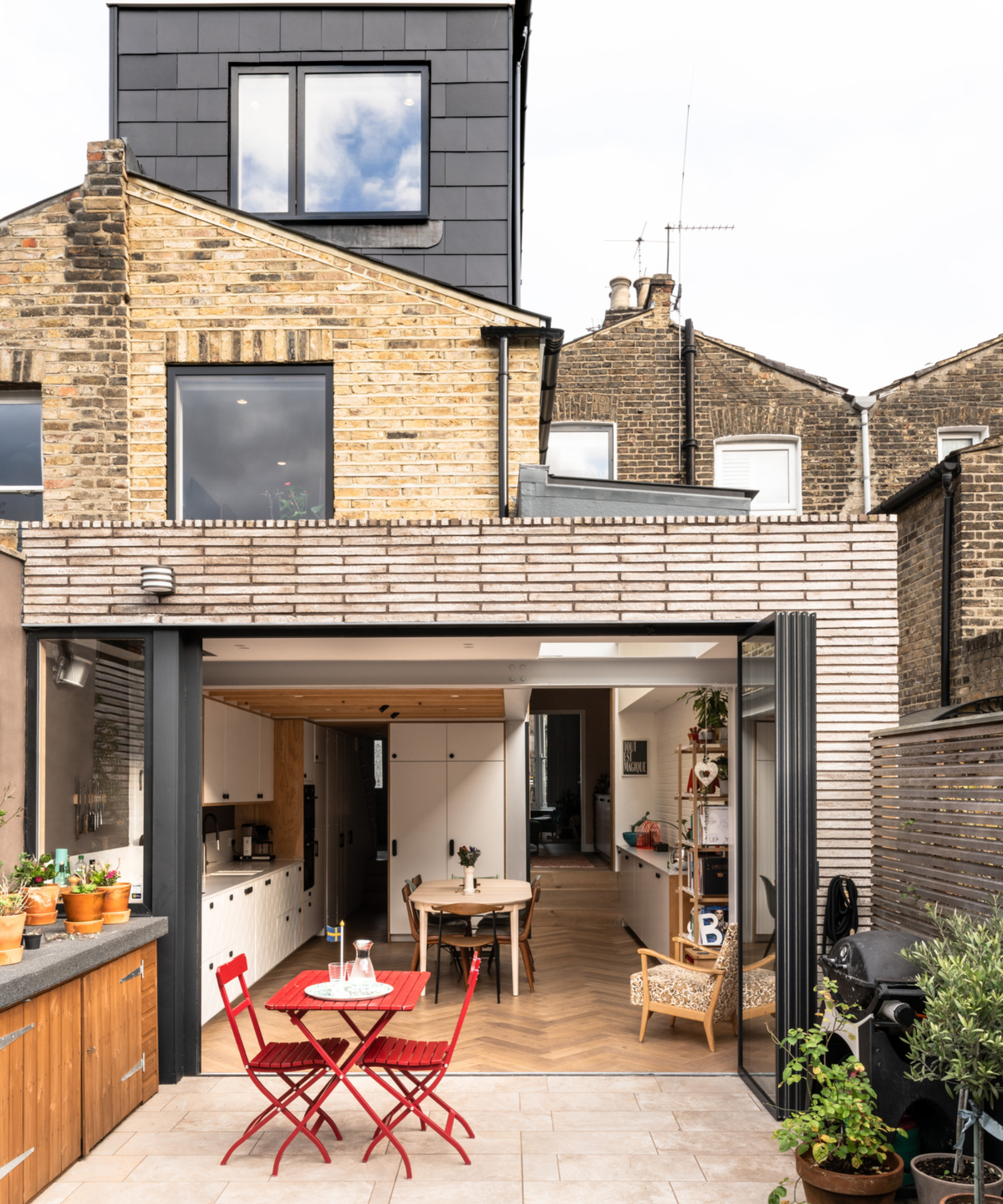 brick extension to rear of property with bi fold windows leading to patio, loft conversion on top of home
