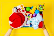 A box of toys on a yellow background