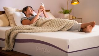 Purple Original vs Purple Plus Mattress: Woman in bed lying on Purple Plus mattress
