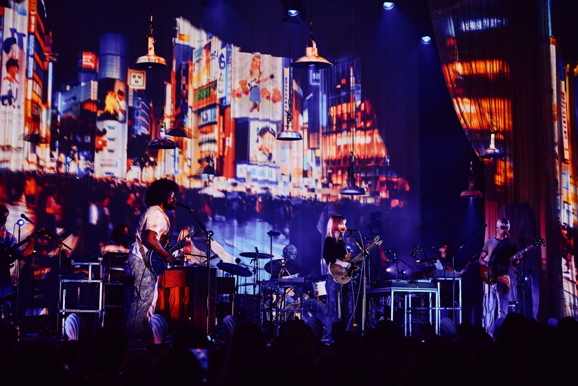 bands on stage in pink light