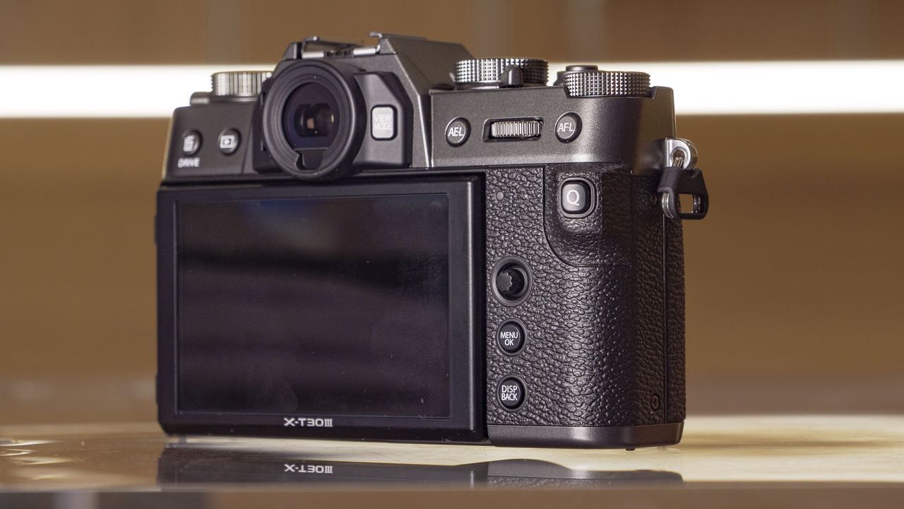 Rear of the Fujifilm X-T30 III camera on a glass table