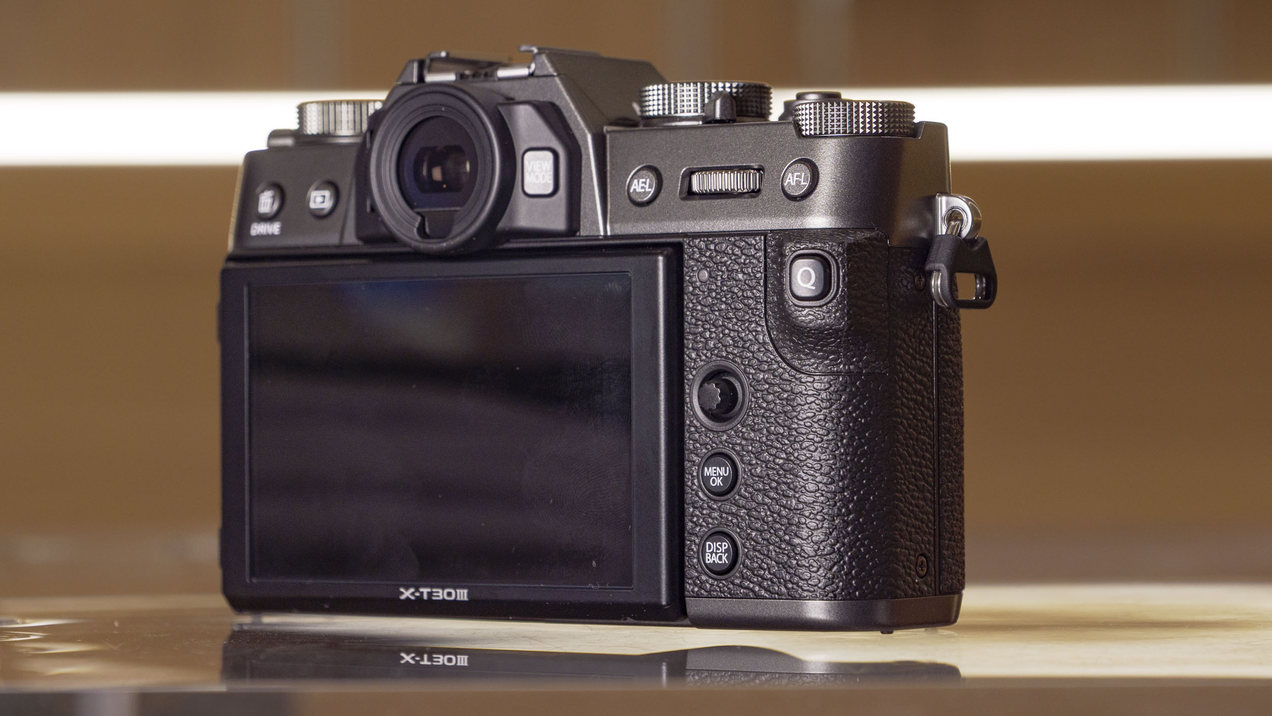 Rear of the Fujifilm X-T30 III camera on a glass table