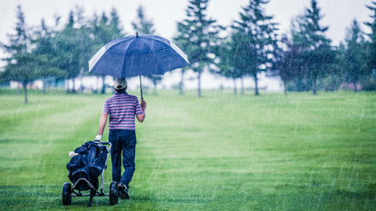 Golfer on a Rainy Day Leaving the Golf Course 