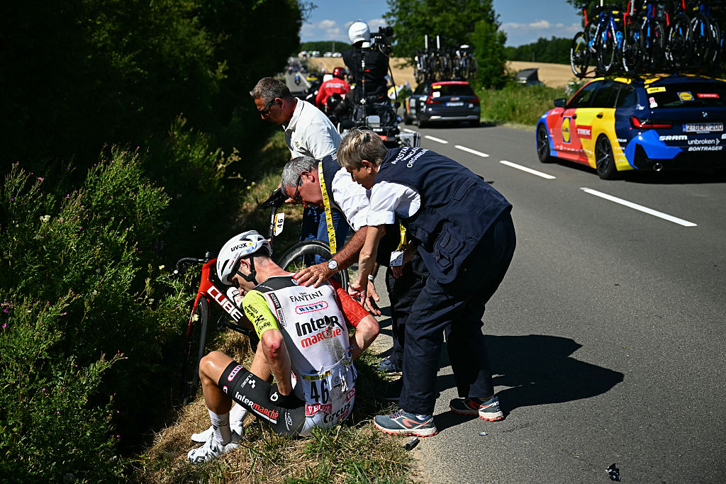 Intermarch - Wanty team's German rider Jonas Rutsch receives medical assistance after suffering a crash during the 8th stage of the 112th edition of the Tour de France cycling race, 171.4 km between Saint-Meen-le-Grand and Laval Espace Mayenne, western France, on July 12, 2025. (Photo by Loic VENANCE / AFP) (Photo by LOIC VENANCE/AFP via Getty Images)