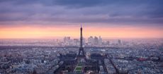 F3M5RC Paris cityscape clad in pink at dusk. Aerial view of Paris and the Eiffel Tower, Champ de Mars, Trocadero and La Defense