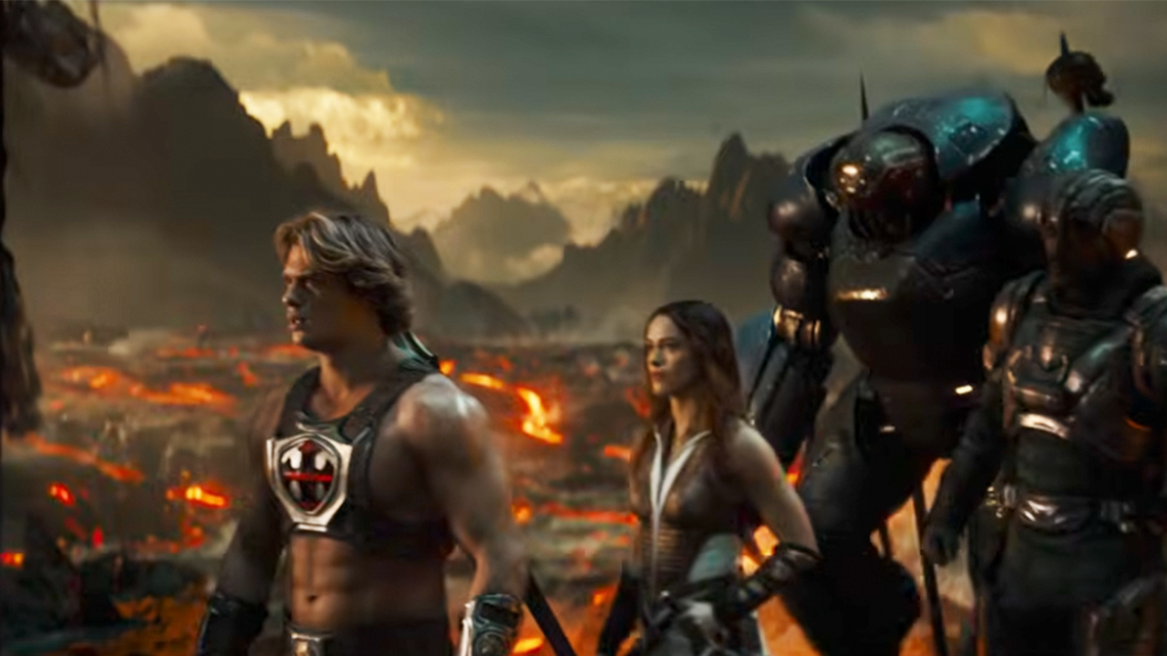 The cast of Masters of the Universe in front of a lot of fire and smoke.