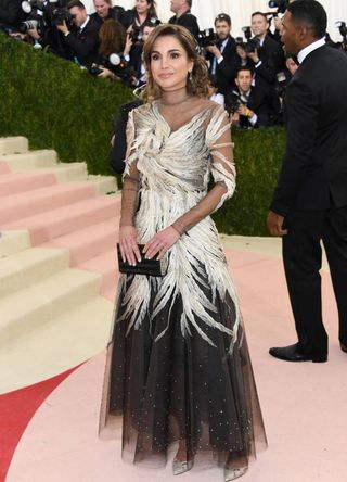 Queen Rania of Jordan outside the Met Gala wearing a silver dress