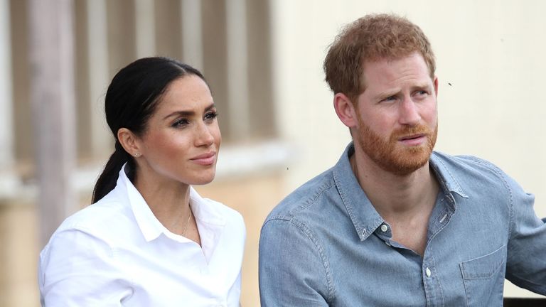Prince Harry and Meghan Markle pose for the camera 