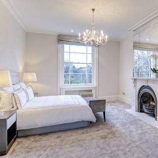 white bedroom with white lamp lights and white window