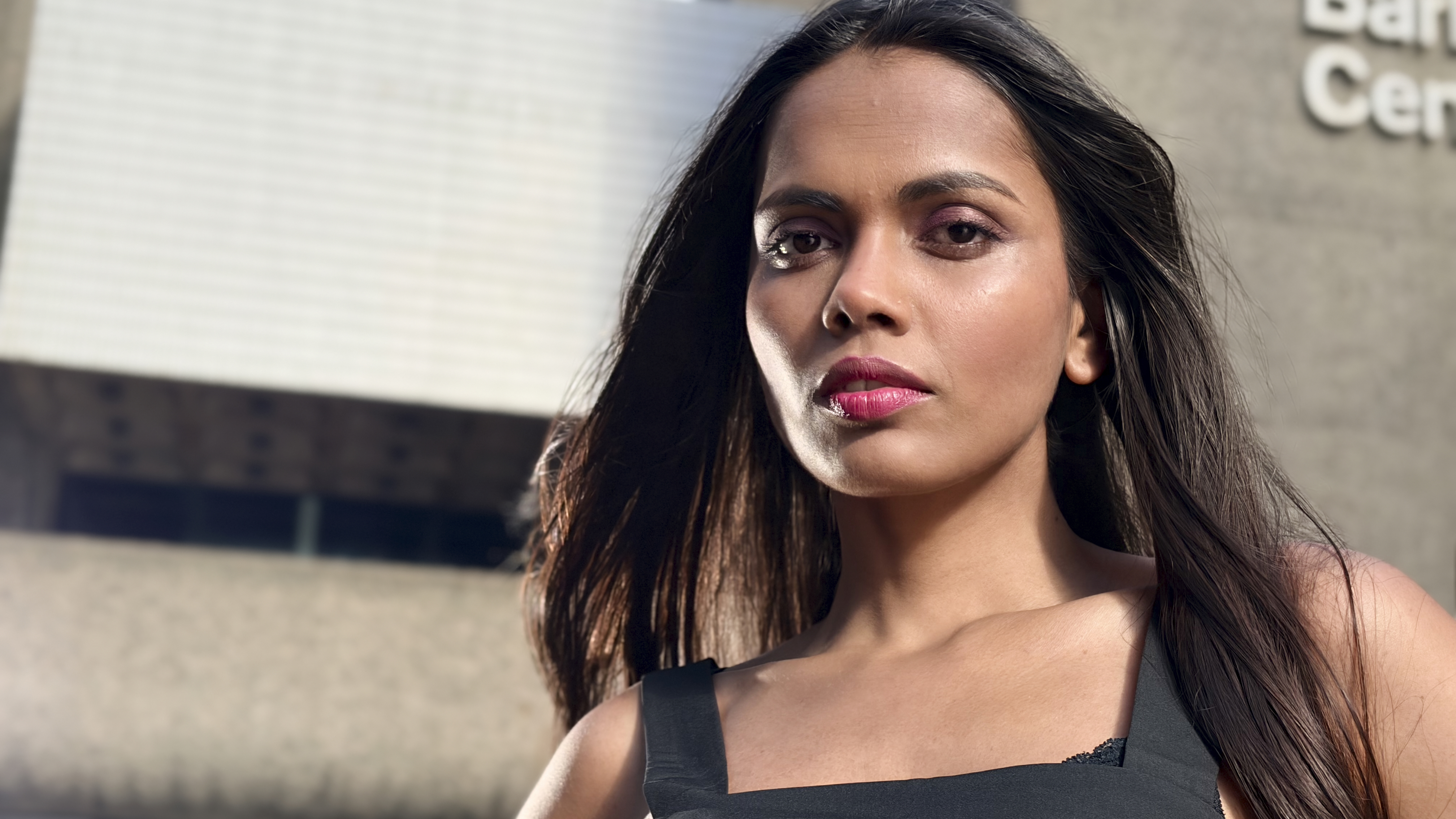 A close-up portrait. The side of her face is slightly illuminated by light from the Godox ML150Bi to help sculpt the face with a more three-dimensional look, rather than being flat-lit from the front.