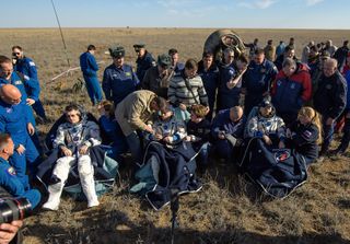 NASA astronaut Shane Kimbrough (left) and Russian cosmonauts Sergey Ryzhikov (center) and Andrey Borisenko (right) are seen seated shortly after landing their Soyuz spacecraft on the steppes of Kazakhstan on April 10, 2017. The trio spent 173 days in space during their Expedition 50 mission.