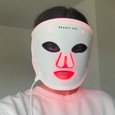 Beauty editor Eleanor Vousden wearing a Beauty Pie LED mask