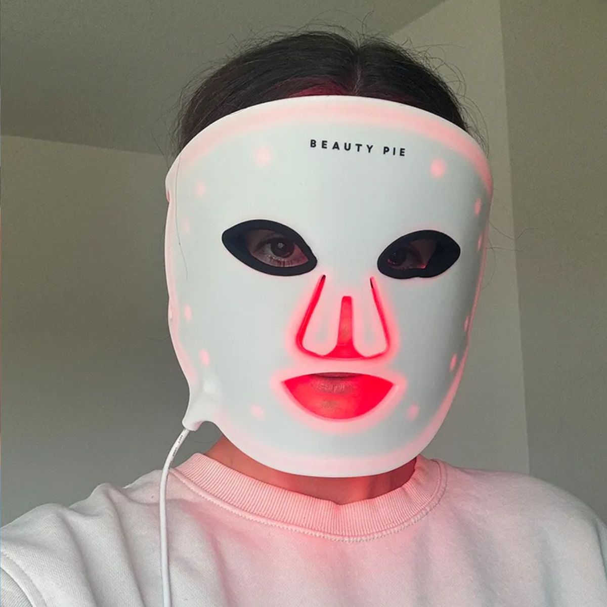 Beauty editor Eleanor Vousden wearing a Beauty Pie LED mask
