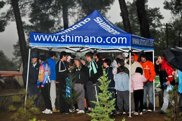 Racers seek shelter while awaiting the awards ceremony.