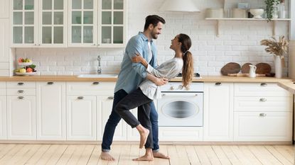 A happy couple dancing in their kitchen