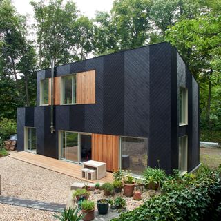 exterior of modern prefab home with black wooden panelling