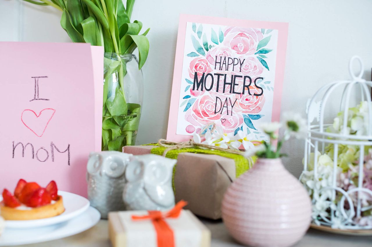 Beautiful Mothers Day greeting card, cake and presents on table