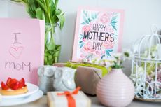 Beautiful Mothers Day greeting card, cake and presents on table