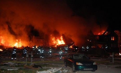 Firefighters work the scene where the explosion and fire occurred on Nov. 10.