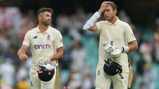 James Anderson (L) and Stuart Broad of England leave the field after England's last pair held out for a draw in the Fourth Test