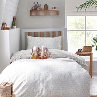 Children's bedroom with white walls, and bed with alphabet duvet set