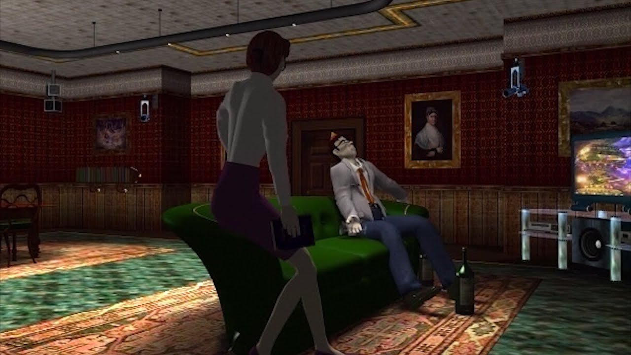 A man sits on a sofa as a woman approaches.