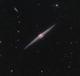 a thin needle-like galaxy in deep space