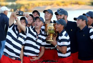 Justin Thomas (left of trophy), Rickie Fowler (holding trophy) Jordan Spieth (centre) and other members of the victorious United States team enjoy taking a 'selfie' with the Presidents Cup after their 19-11 victtory during the final day singles matches matches in the 2017 Presidents Cup at the Liberty National Golf Club on October 1, 2017 in Jersey City, New Jersey.