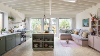 two tone kitchen in green and pink with wood flooring