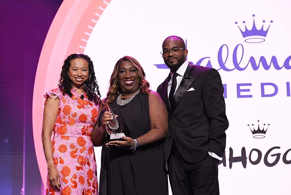 (From l.): Walter Kaitz Foundation dinner co-chairs Dalila Wilson-Scott of Comcast and Detavio Samuels of Revolt with Toni Judkins, senior VP of programming development, Hallmark Media, who accepted the ChangeMaker award for the network&rsquo;s Mahogany content initiative.