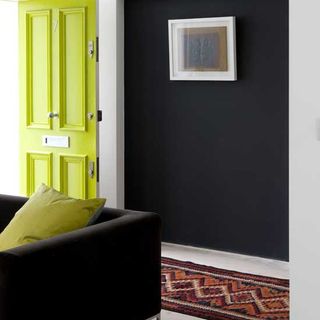 living room with yellow door and black door
