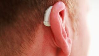 A stock image of a man wearing a hearing aid